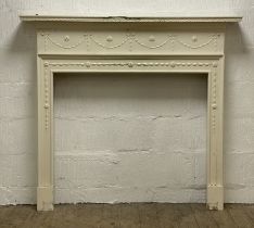 A white painted pine fire surround in the Neo-Classical style, the frieze decorated with harebell