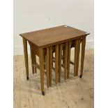 Poul Hundvad, a mid century teak nest of tables moving on castors. H47cm, W62cm, D42cm.