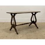 A Regency style mahogany coffee table, the shaped top with reeded edge raised on lyre form supports,