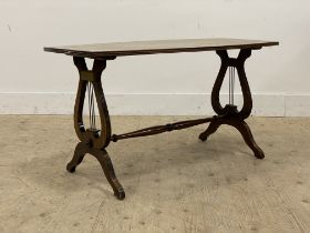 A Regency style mahogany coffee table, the shaped top with reeded edge raised on lyre form supports,