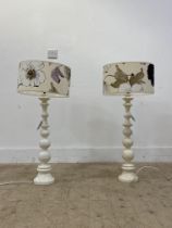 A pair of white painted bobbin turned lamp bases. H68cm.