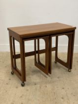 McIntosh, a mid century teak metamorphic nest of three tables, with fold over revolving top and