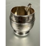 A Walker & Hall Sheffield silver christening cup pf barrel form with circular loop handle and