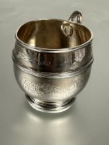 A Walker & Hall Sheffield silver christening cup pf barrel form with circular loop handle and