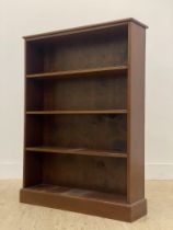 An Edwardian mahogany open bookcase, fitted with three fixed shelves and raised on a plinth base.