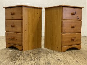 A pair of polished pine three drawer bedside chests. H70cm, W49cm, D45cm.