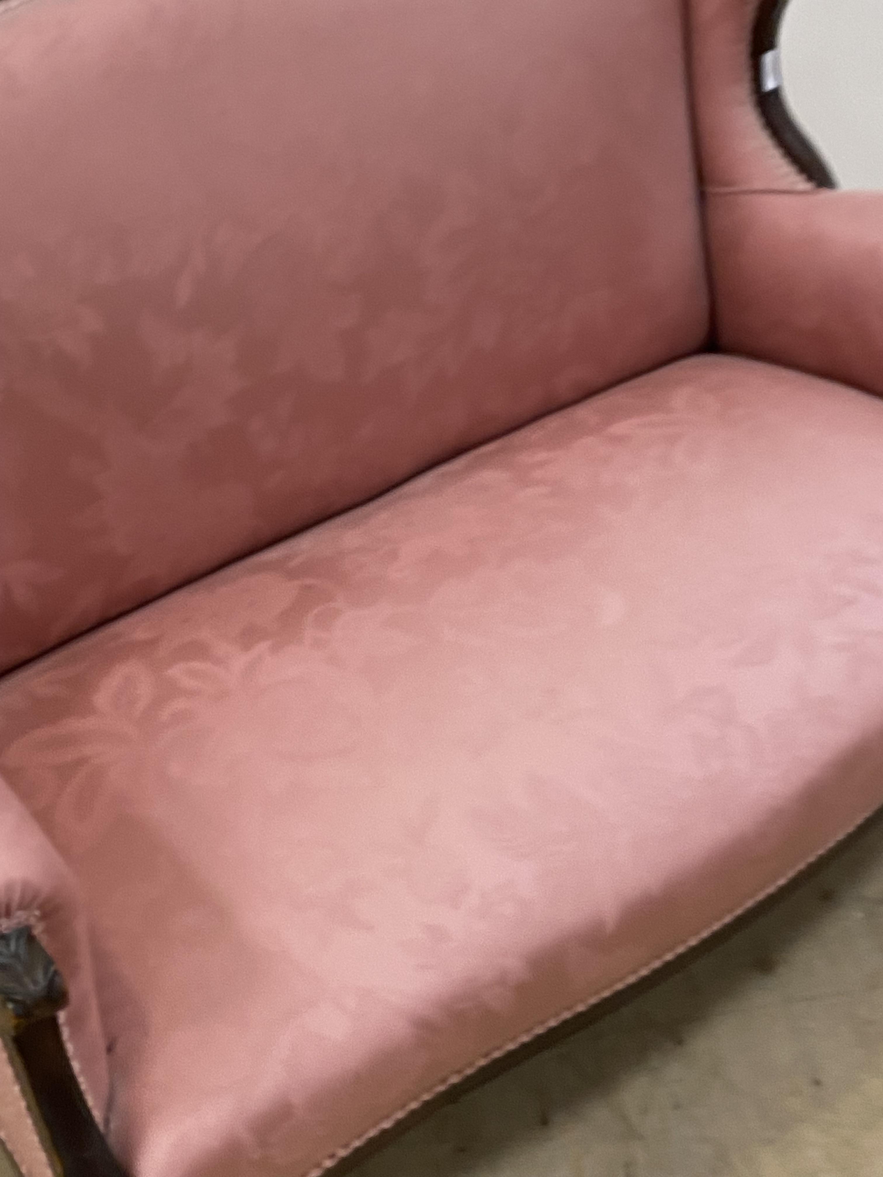 A late Victorian two seat sofa, the floral carved mahogany show frame enclosing pink damask - Image 2 of 2