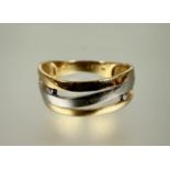 A 14 carat yellow and white gold open work scroll ring mounted two channel set points 0.050ct O 2.6g