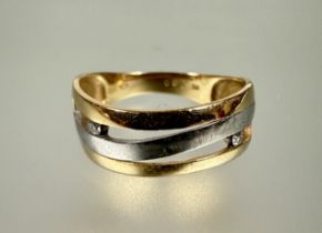 A 14 carat yellow and white gold open work scroll ring mounted two channel set points 0.050ct O 2.6g