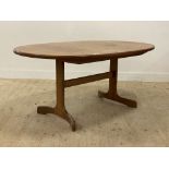 G-plan, a mid century teak extending dining table, the oval top opening for a fold out leaf,