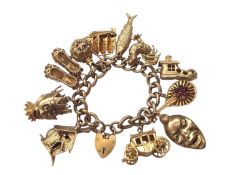 9ct gold charm bracelet with eleven 9ct gold novelty charms