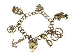 9ct gold charm bracelet with padlock clasp and seven novelty charms