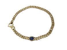 18ct gold curb link bracelet set with a cabochon blue sapphire and a brilliant cut diamond