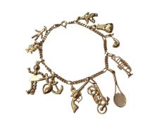 18ct gold charm bracelet with eleven 18ct gold novelty charms