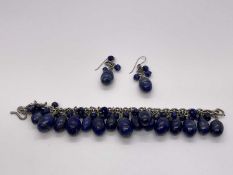 Silver and lapis lazuli bracelet and earrings, the silver chain links suspending egg-shaped lapis la