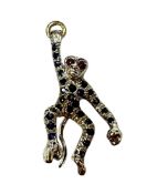 Gold (18ct) novelty pendant in the form of a swinging monkey suspended from a gold ring with ruby ey