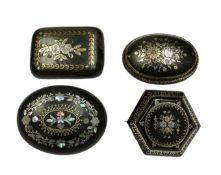 Group of four 19th century tortoishell piqué work brooches with floral decoration. 35mm-45mm