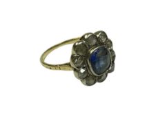 Antique sapphire and diamond flower-head cluster ring with a central oval mixed cut blue sapphire su