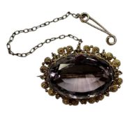 19th century amethyst brooch with oval facet cut stone within a canatille surround, measuring approx