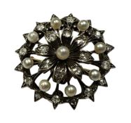 Late Victorian diamond and seed pearl pendant / brooch of snowflake design, with flower-head cluster