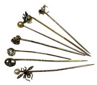 Seven antique stick pins to include three gold and gem-set novelty insect stick pins