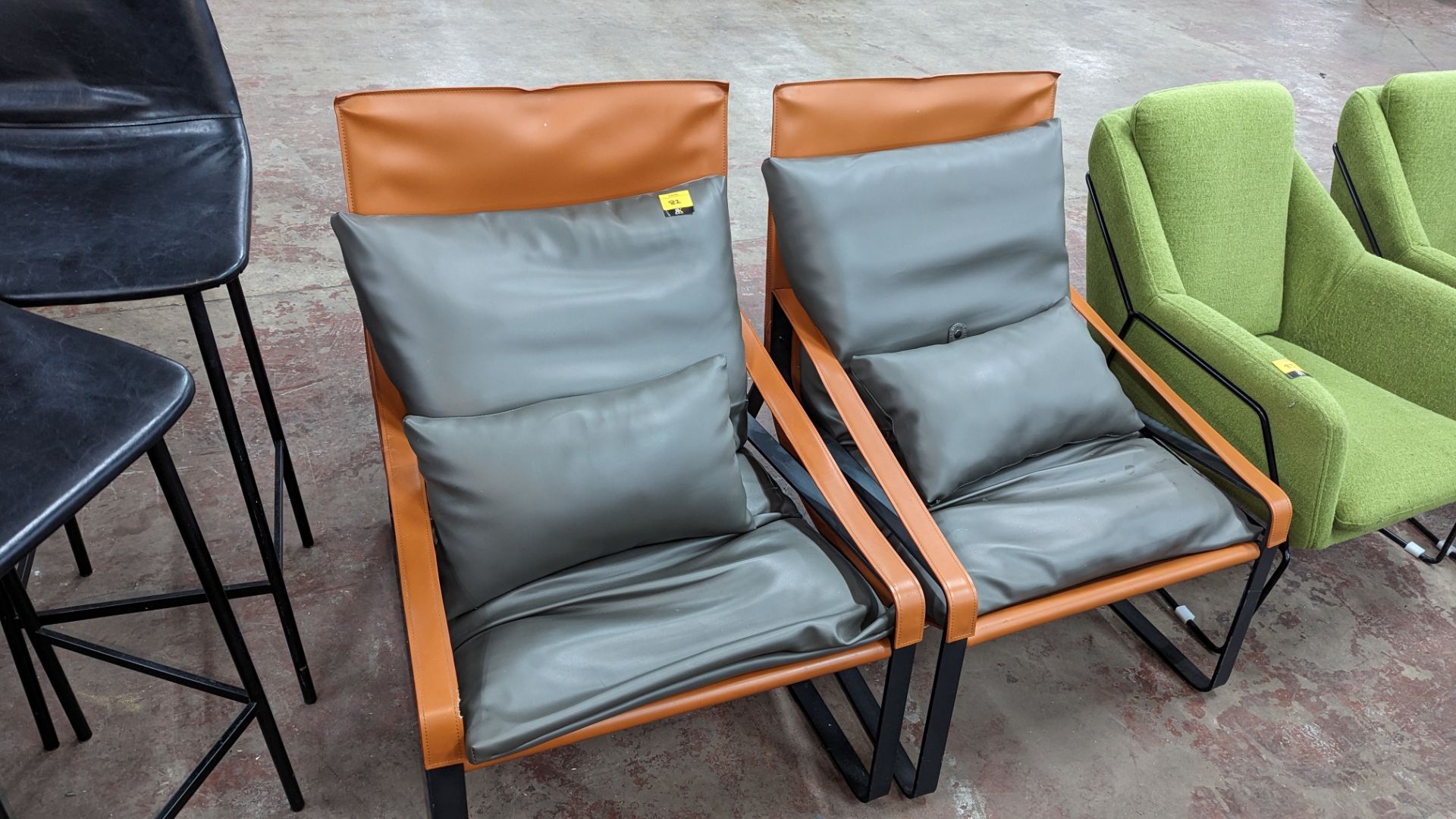 2 chairs on heavy duty black metal frames with tan colour pleather fabric and grey cushioning