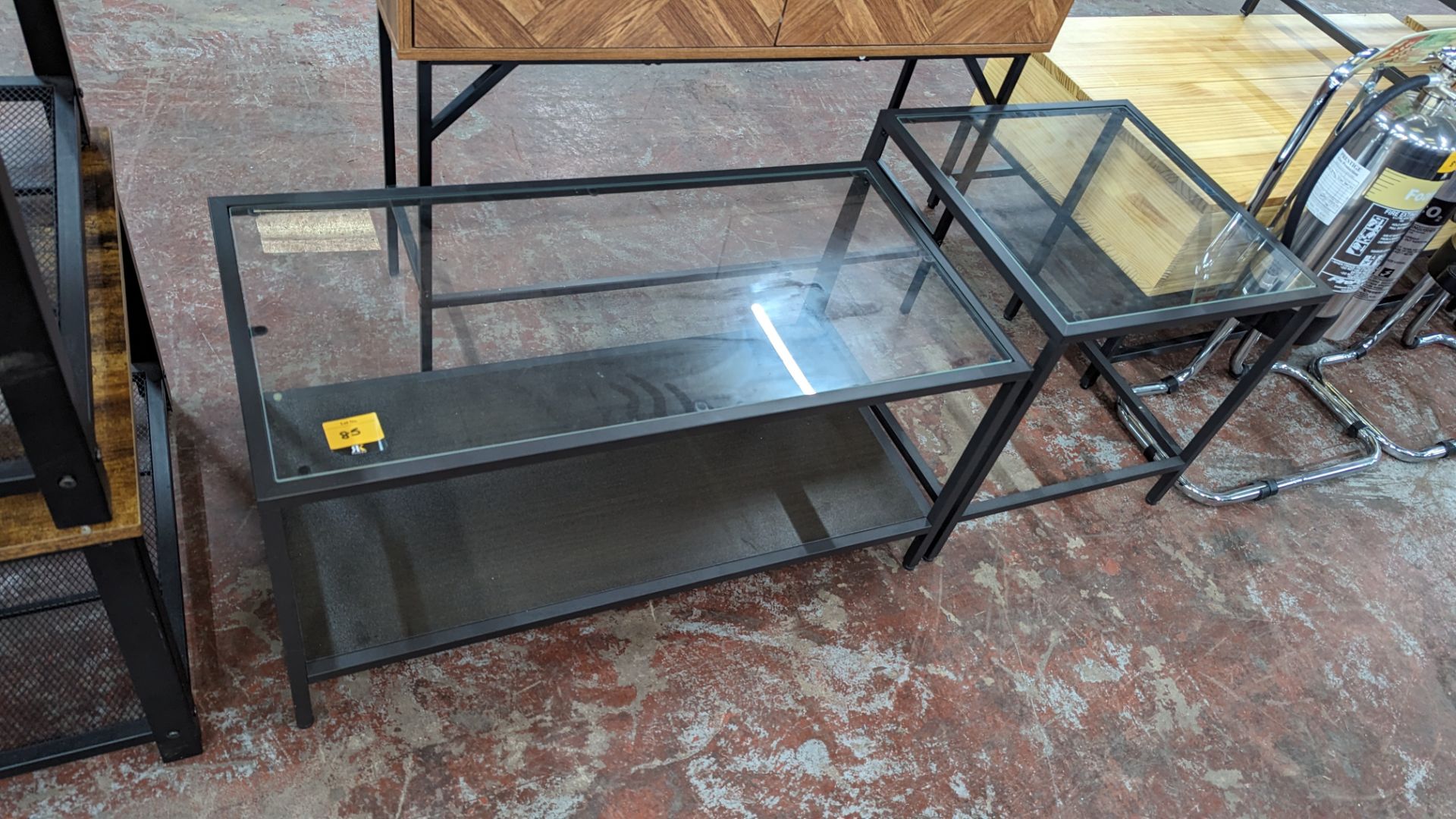 Pair of matching occasional tables dark grey metal with glass tops, one measuring 900mm x 450mm and