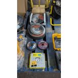 Row of assorted sized angle grinder discs - 5 stacks in total