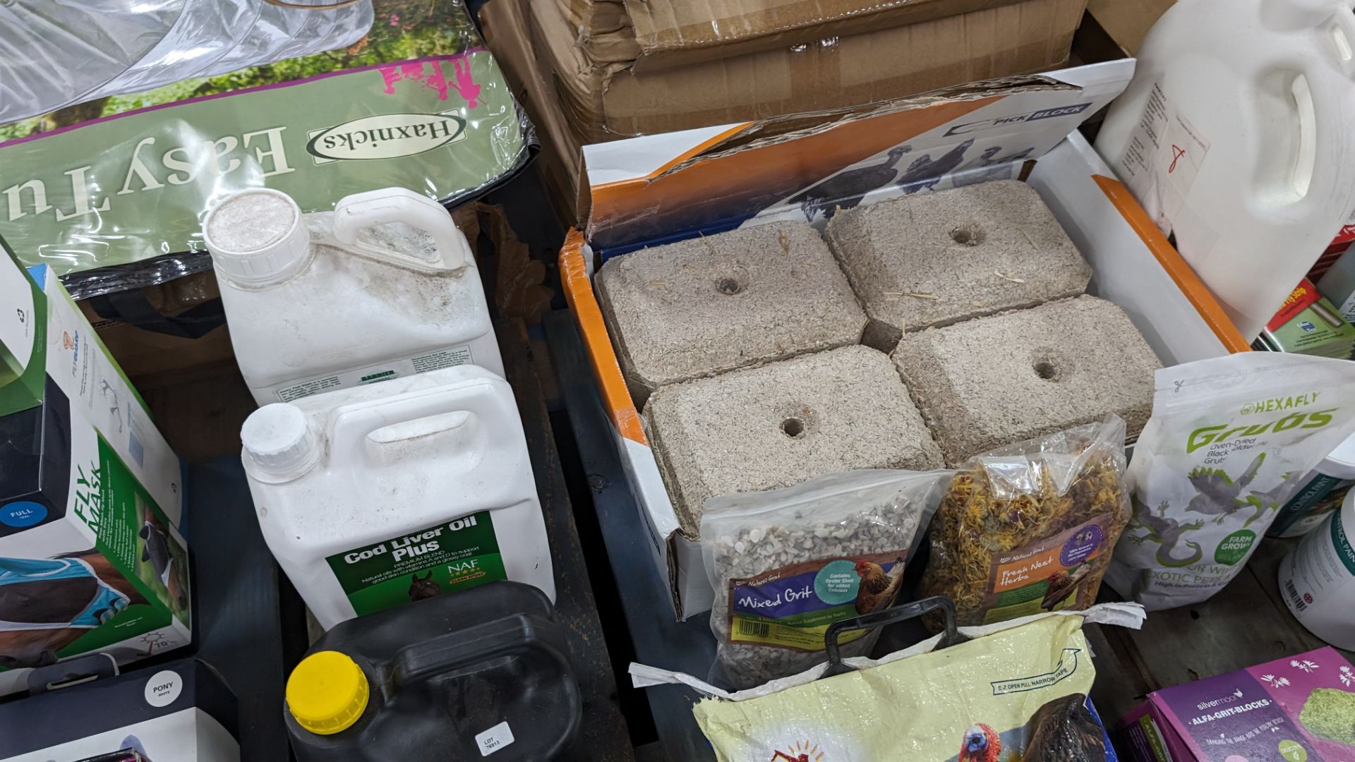 The contents of a pallet of animal related items including horse mesh masks, assorted oils, poultry - Image 6 of 10