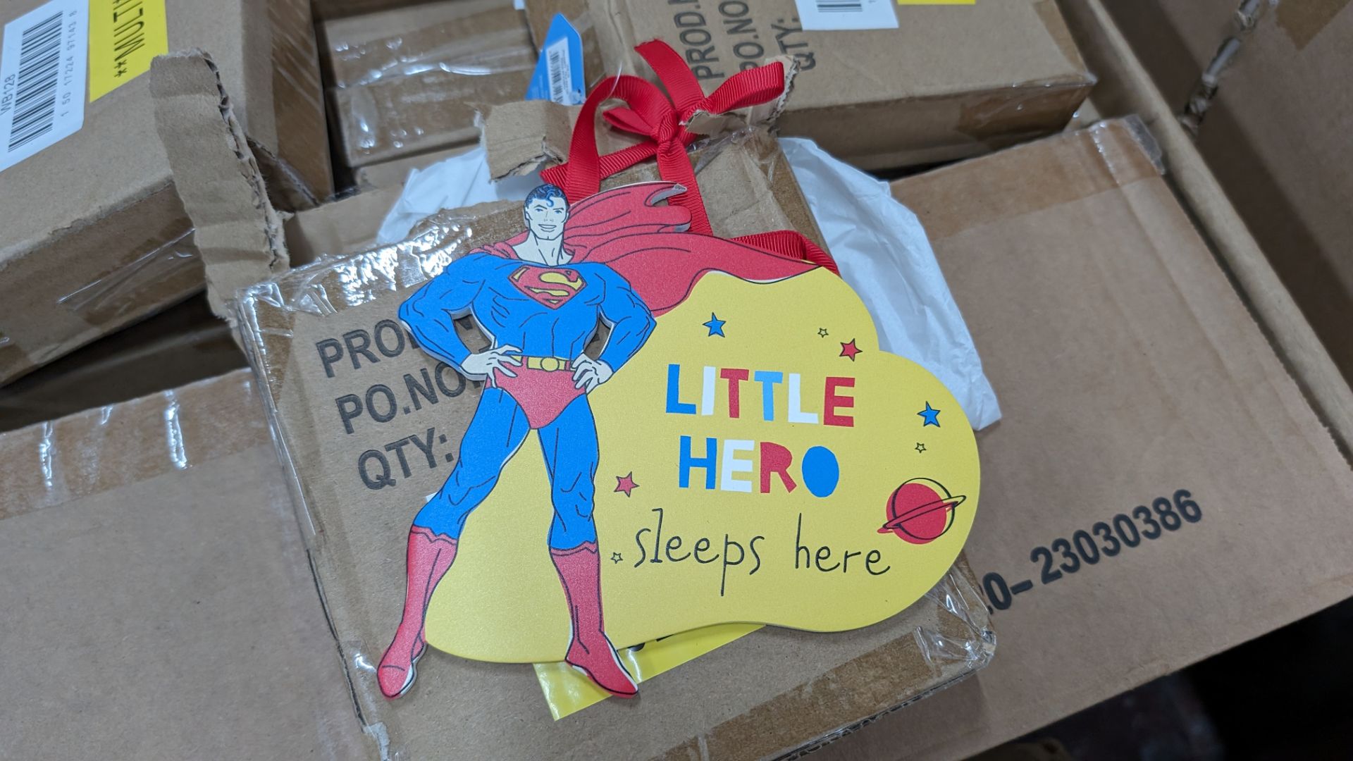 Box of Superman hanging door signs