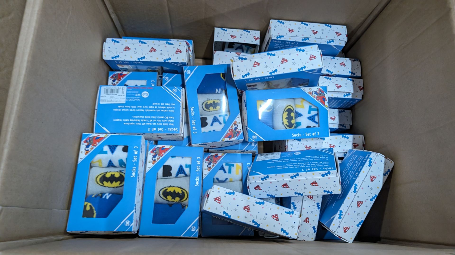 Box of DC Comic Super Hero branded socks in triple packs