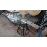 Large round glass table on black metal frame, table top approximately 1100mm diameter