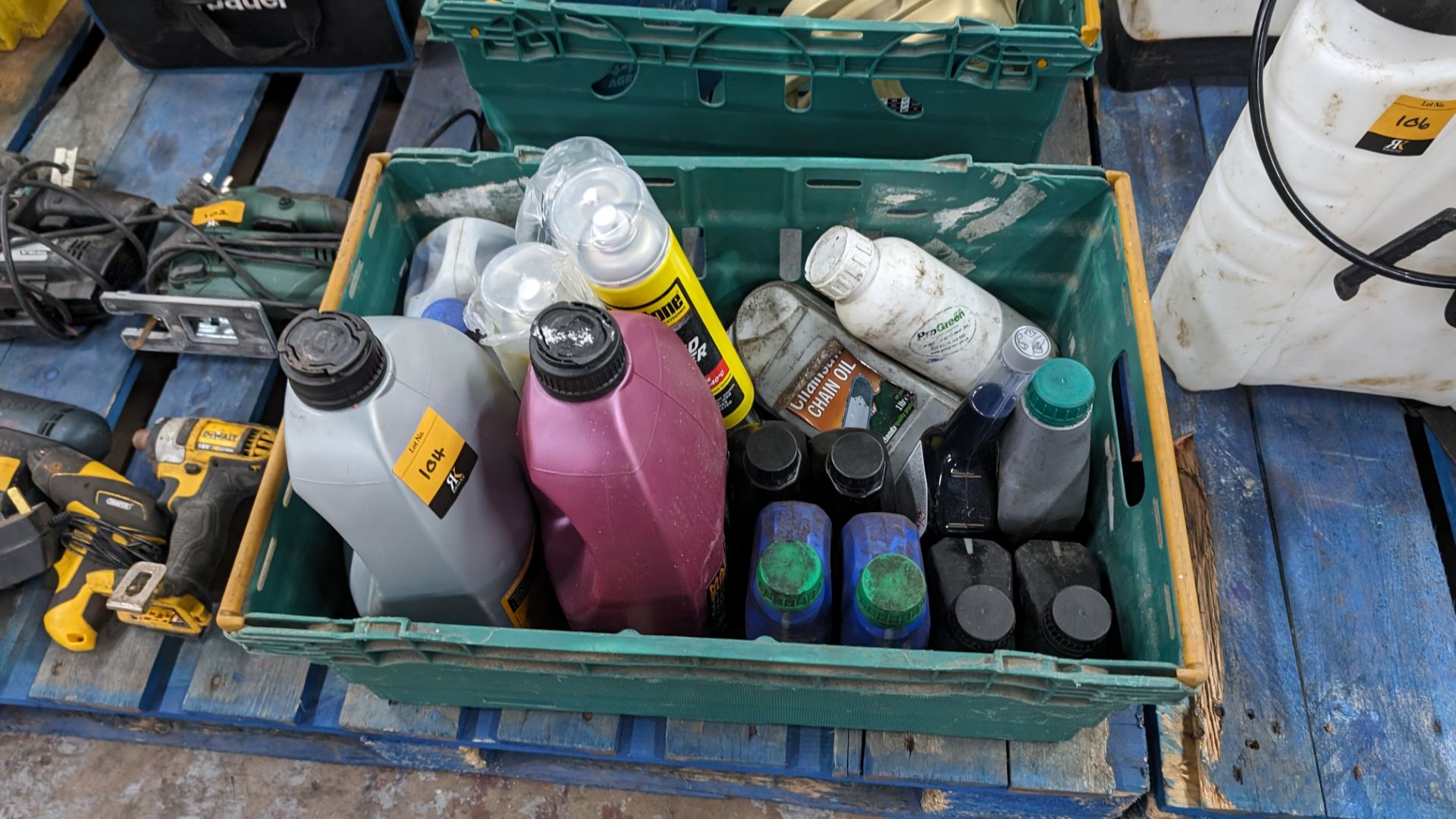 The contents of a crate of assorted fluids including chain oil, de-icer & more