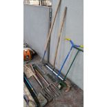 Quantity of assorted garden tools including forks, spades, rakes, choppers & more