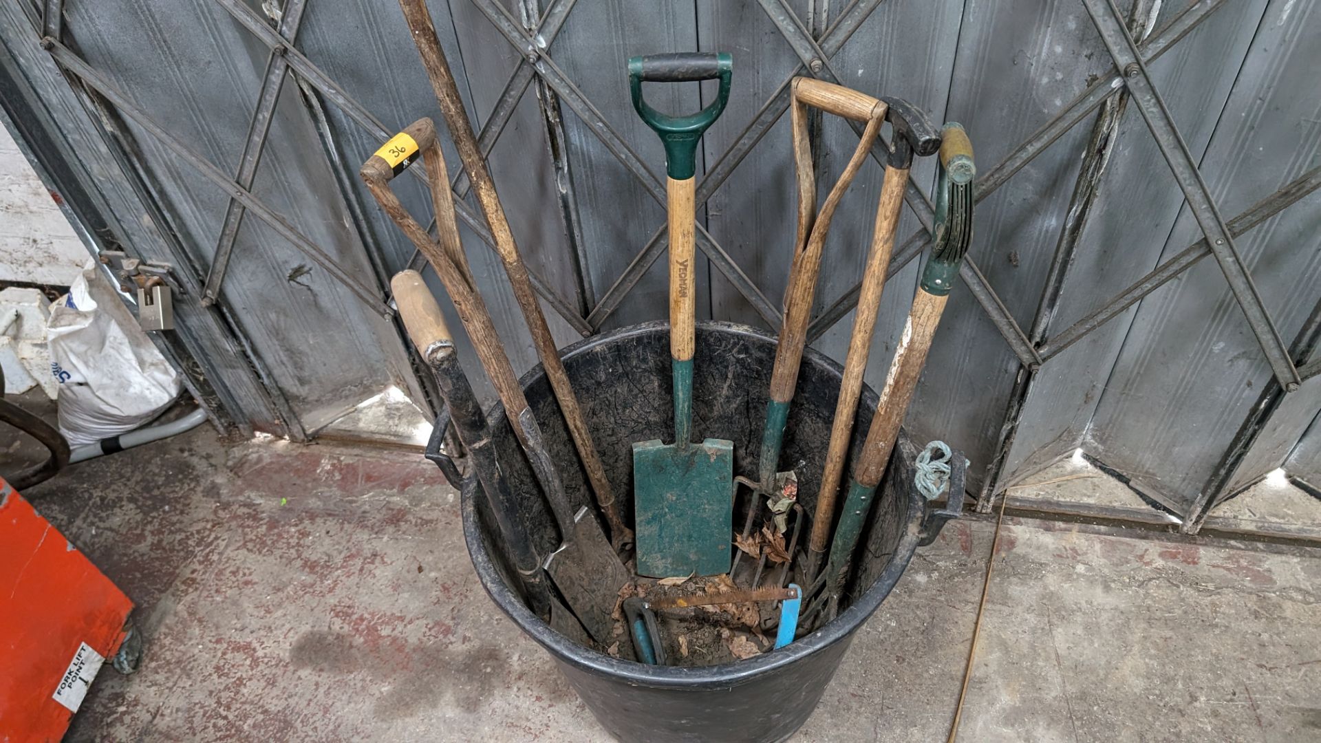 Bucket & contents of assorted long handled spades, forks & other garden implements