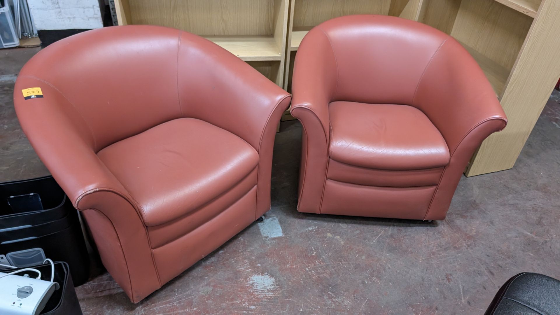 Pair of tub chairs on wheels in dark salmon/terracotta leather/pleather finish - Image 3 of 8