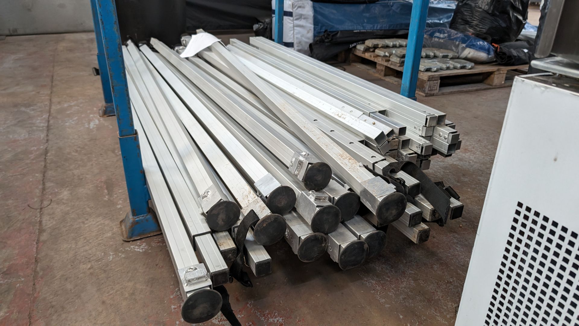 The contents of a stillage of marquee/tent related height adjustable poles and connecting pieces. C - Image 7 of 8