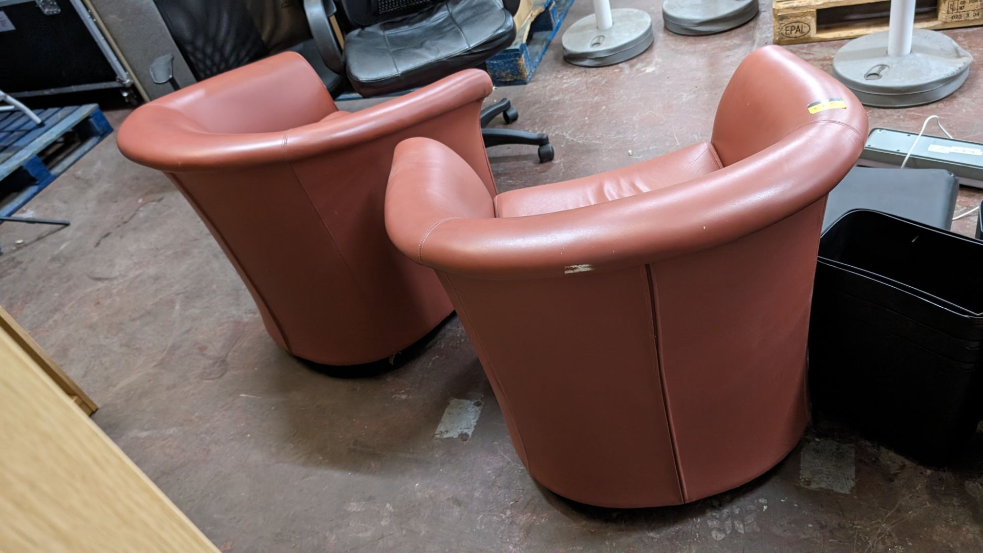 Pair of tub chairs on wheels in dark salmon/terracotta leather/pleather finish - Image 8 of 8