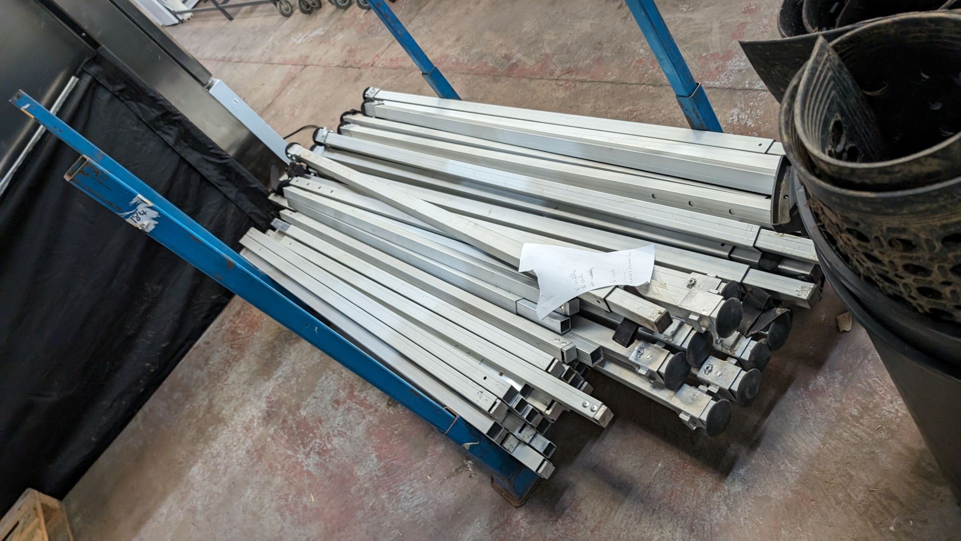 The contents of a stillage of marquee/tent related height adjustable poles and connecting pieces. C - Image 4 of 8