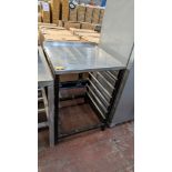 Stainless steel table with capacity for holding trays below, assumed to be for use for commercial di