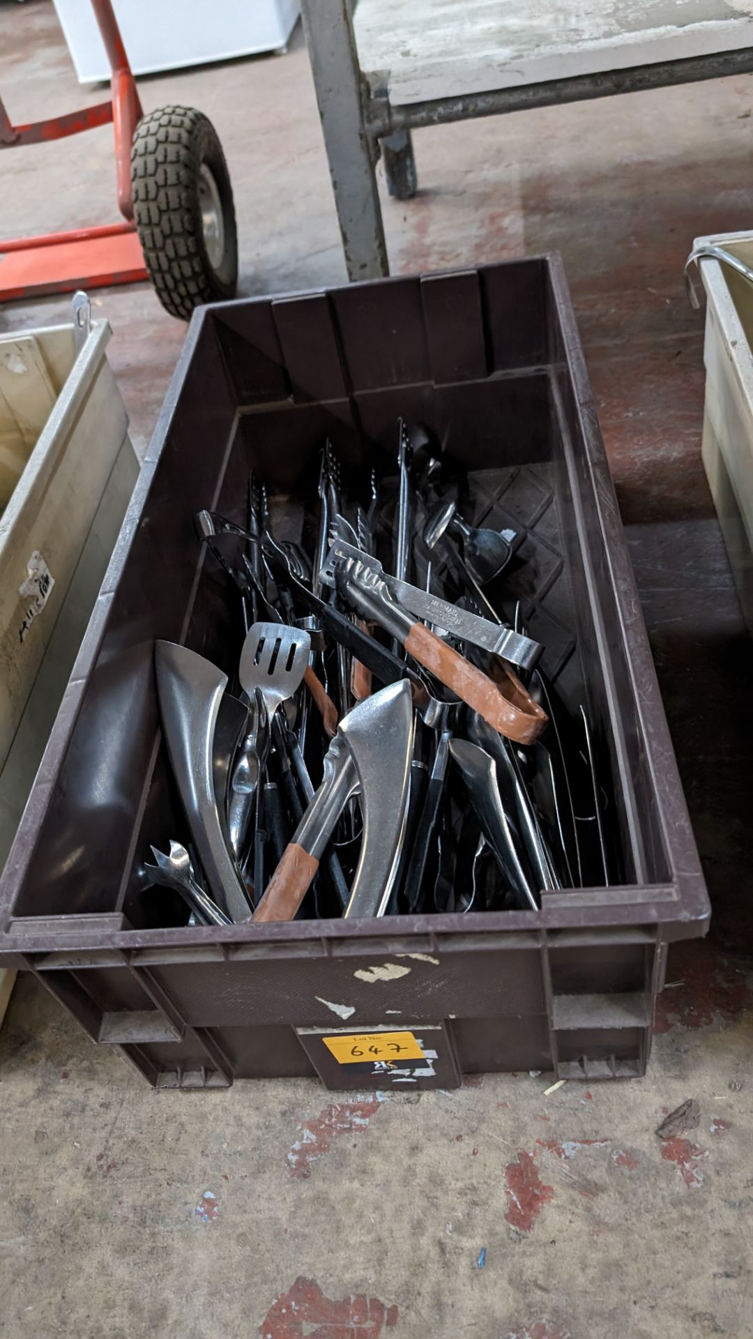 The contents of a crate of assorted tongs and other utensils