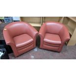 Pair of tub chairs on wheels in dark salmon/terracotta leather/pleather finish