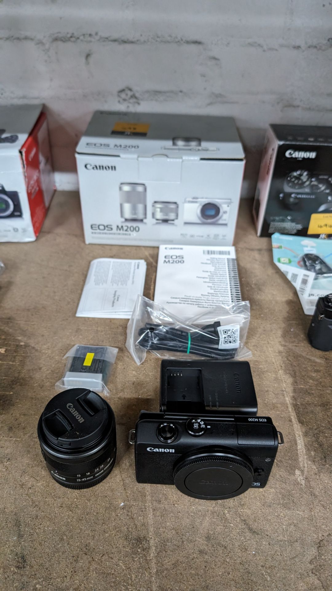 Canon EOS M200 camera kit, including 15-45mm image stabilizer lens, plus battery and charger