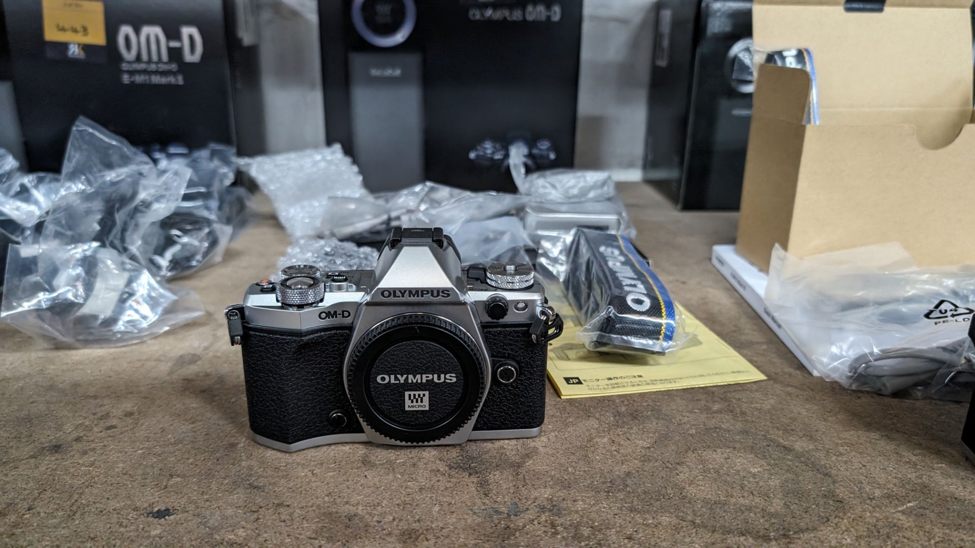 Olympus OM-D E-M5 Mark II camera kit, including camera body, electronic flash, strap, battery, charg