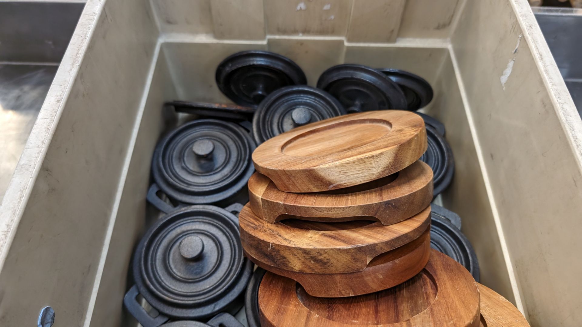 The contents of a crate of Utopia cast iron small pots with lids plus a quantity of wooden stands fo - Image 5 of 6