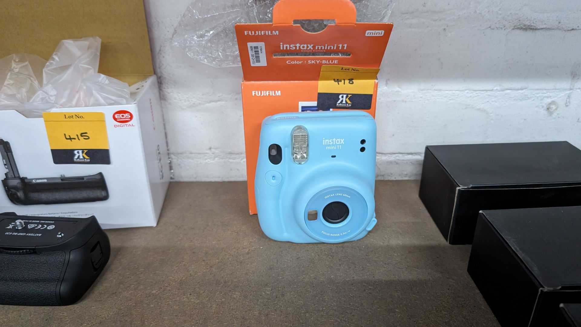 Fujifilm Instax Mini 11 instant camera. In sky blue