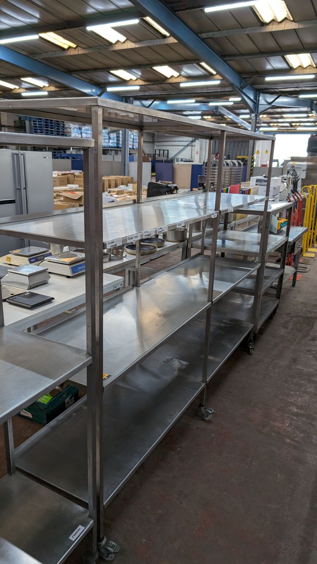 Large stainless steel 4-tier mobile shelving unit with max dimensions of approximately 2,450mm x 580