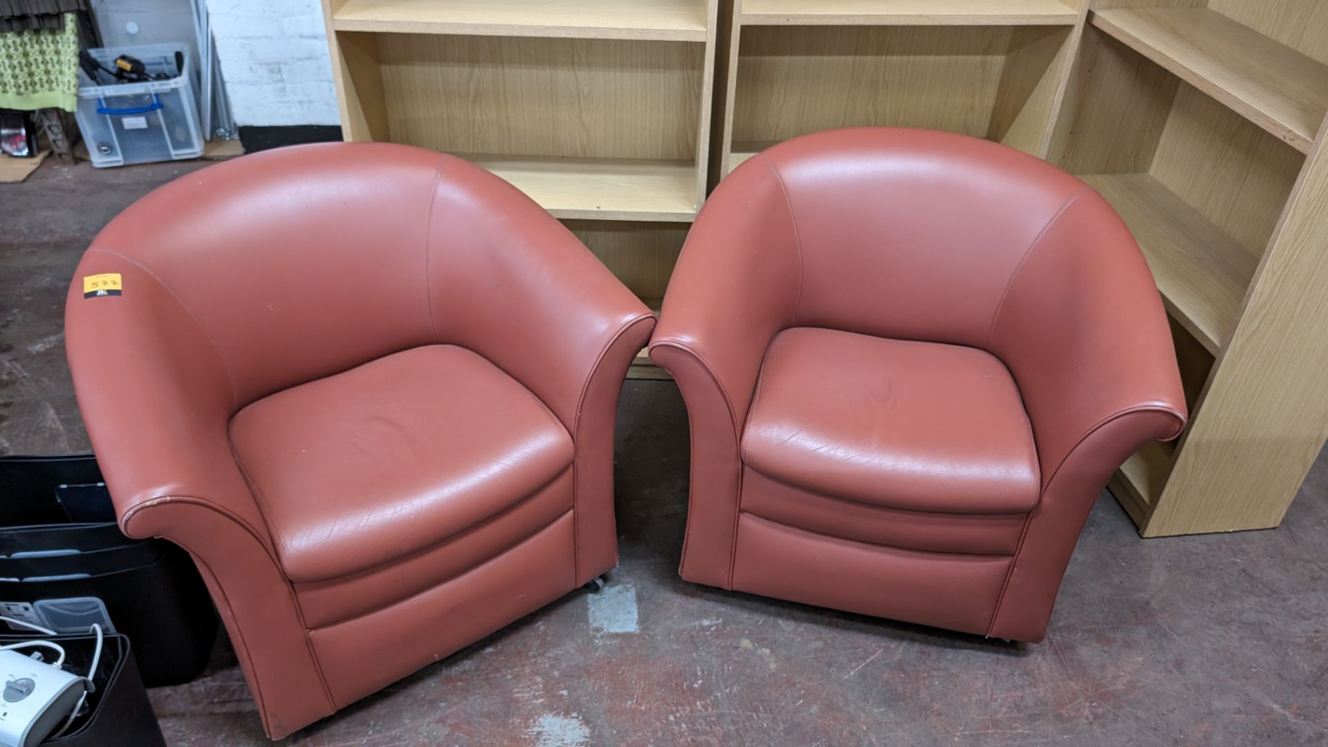 Pair of tub chairs on wheels in dark salmon/terracotta leather/pleather finish - Image 2 of 8