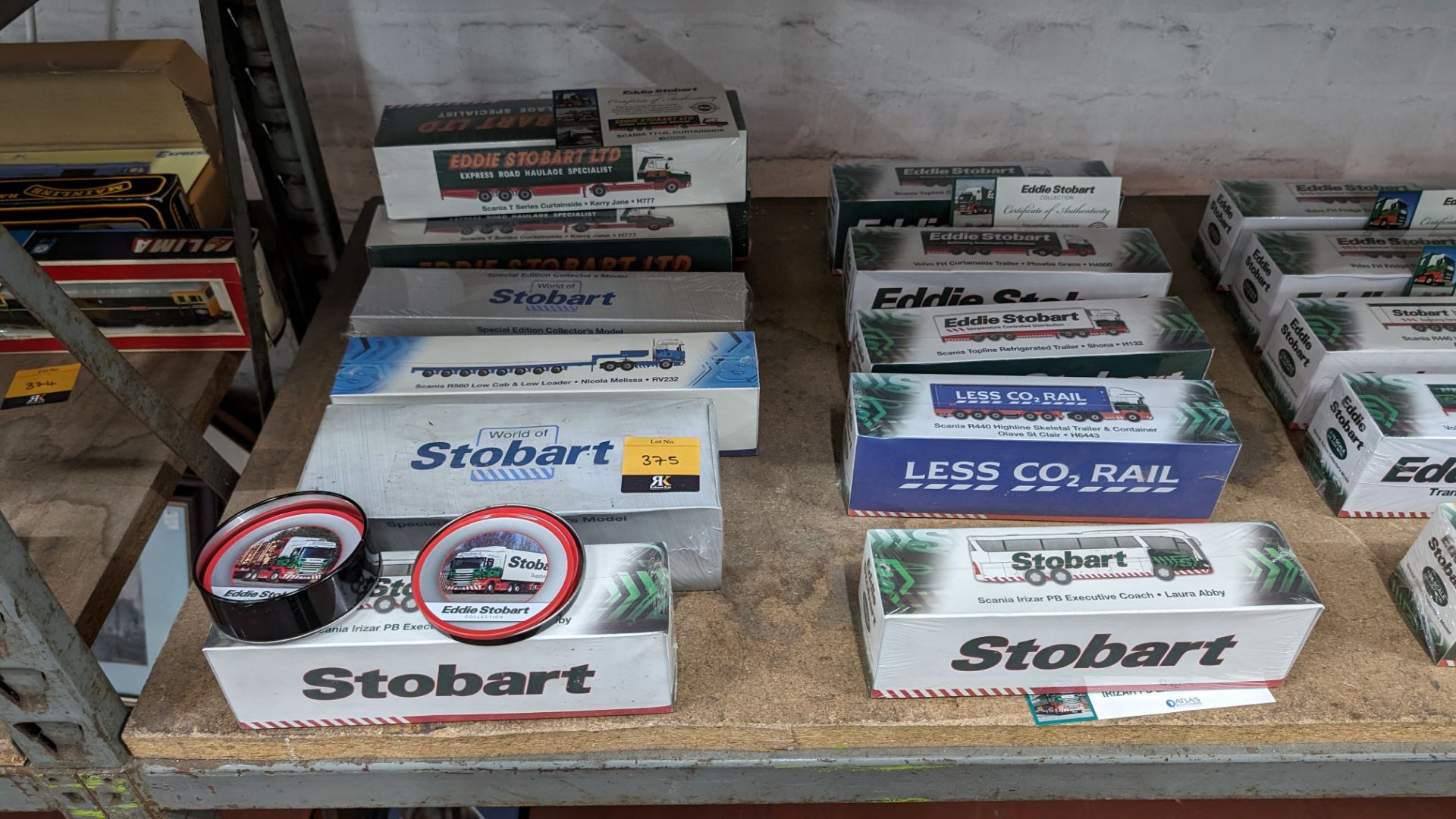 Mixed Eddie Stobart lot comprising 12 assorted model vehicles plus tin of coasters