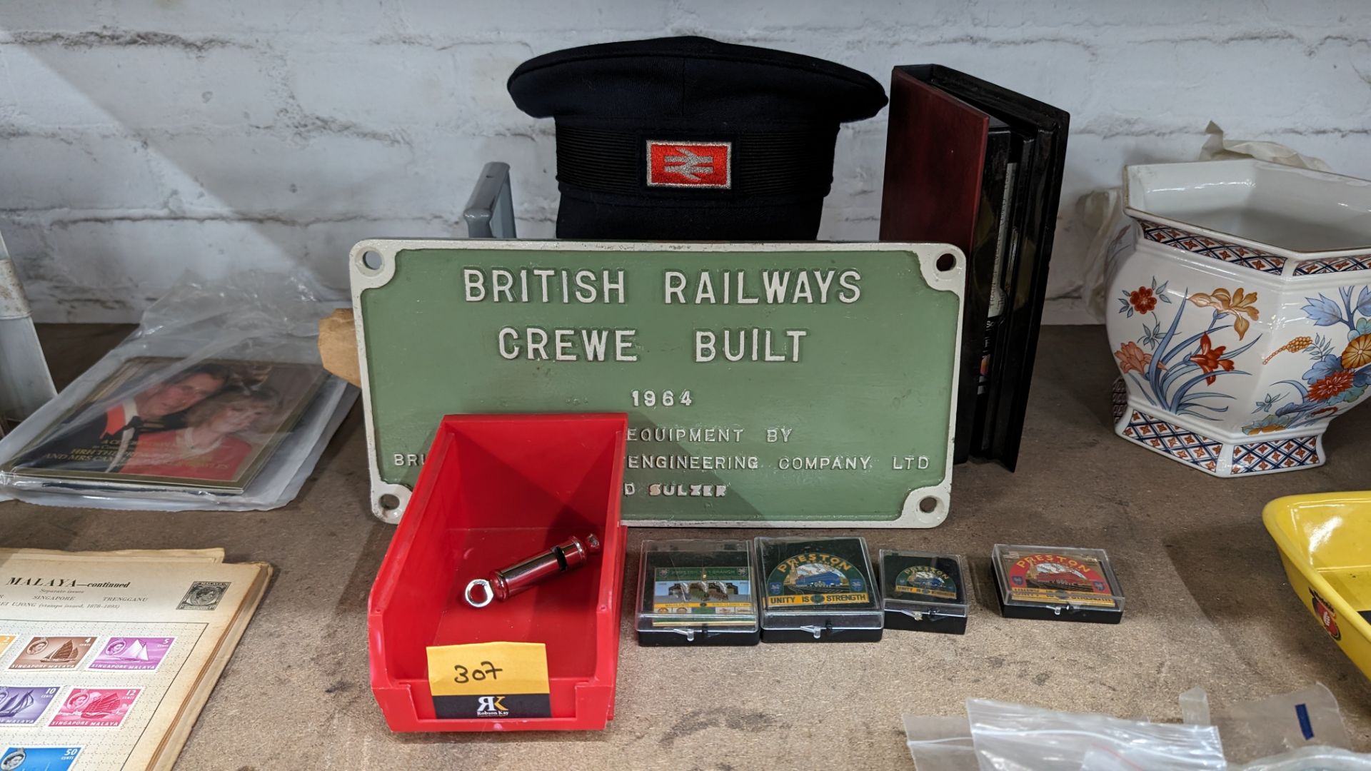 Mixed railway lot comprising plaque, British Rail hat, video, quantity of badges, whistle & lamp